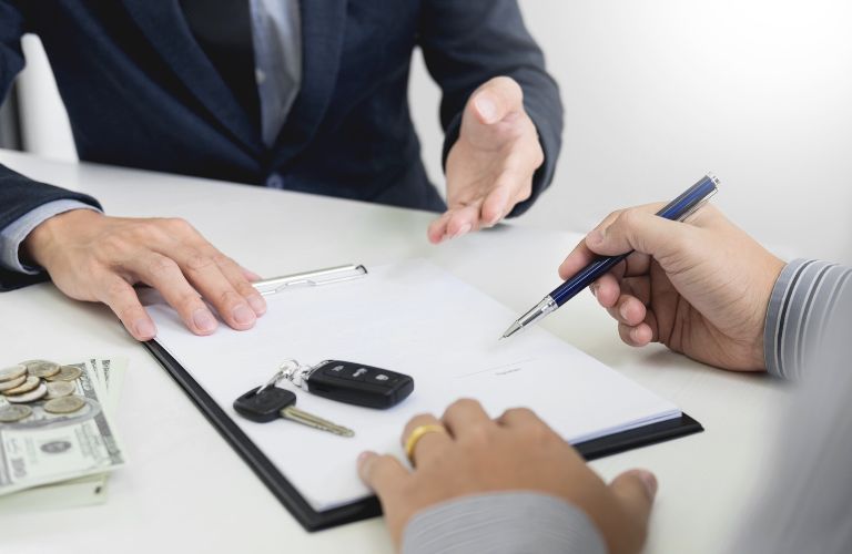 hands of people signing paper