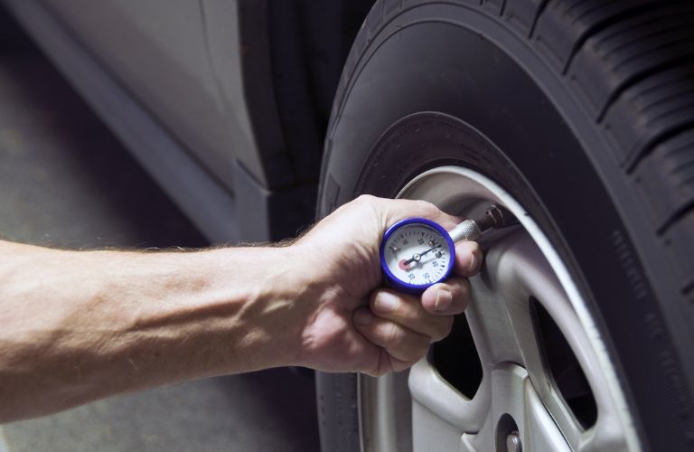 A man checking tire pressure