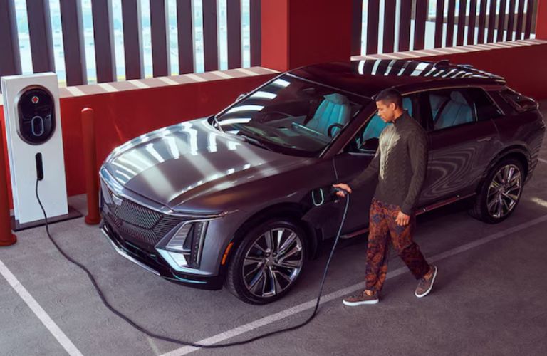 a man charging the 2024 Cadillac LYRIQ