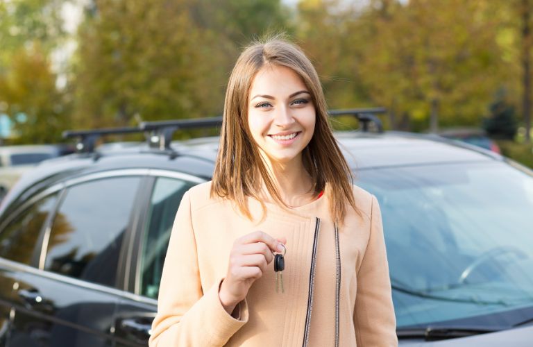 a girl holding a car key