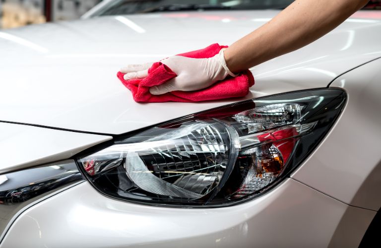 a technician cleaning a headlight