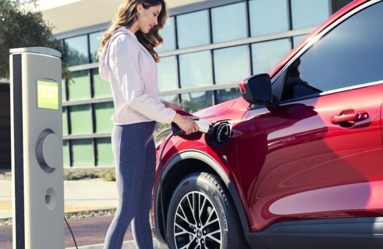 a woman filling fuel in a 2024 Ford Escape®