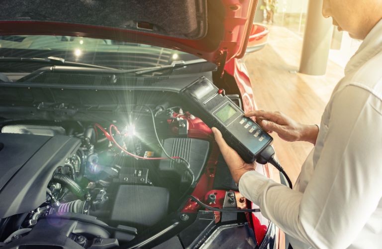 a technician inspecting a car's battery