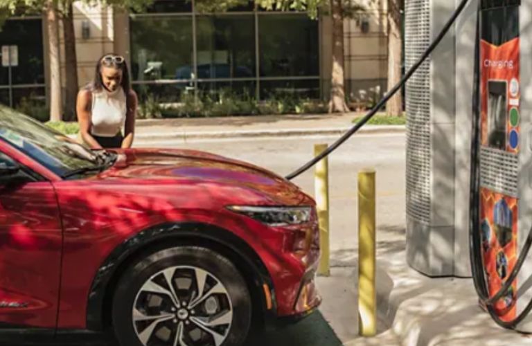 a woman charging her Ford