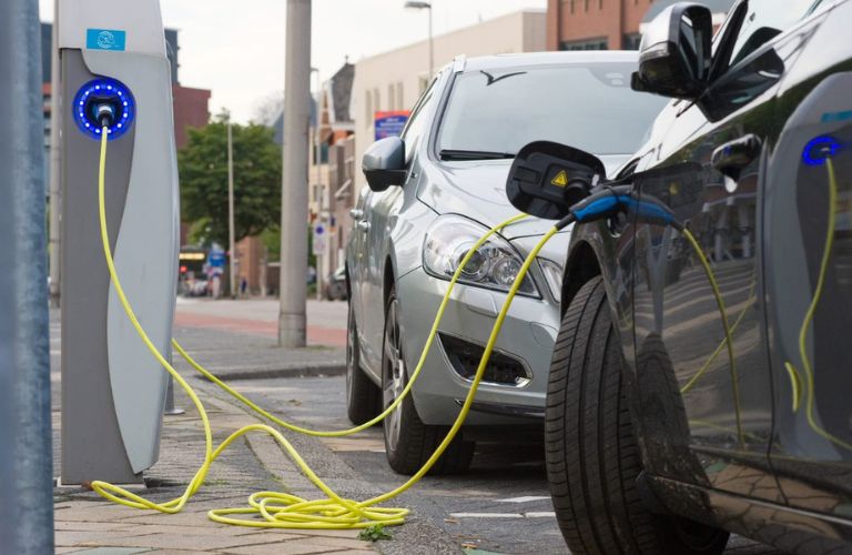 two EVs getting charged at a public charging station