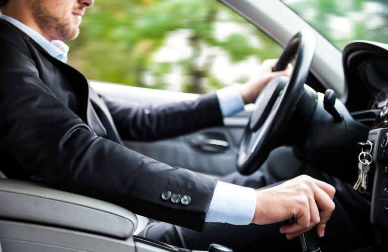 image of a man driving a car