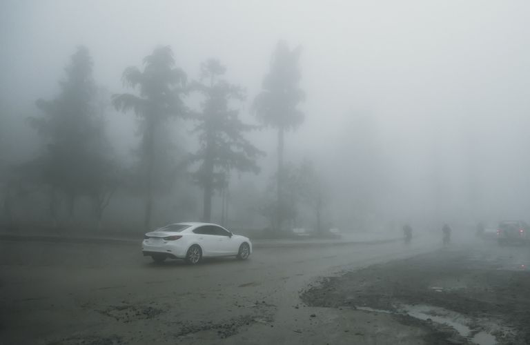 rear view of a car being driven in fog