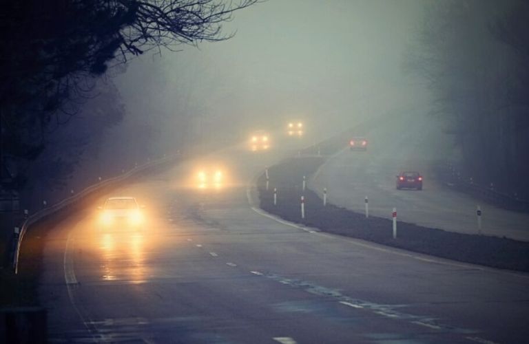 front view of cars driven in fog