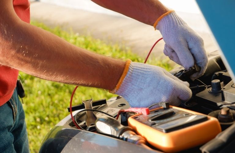 a technician checking the battery of a car