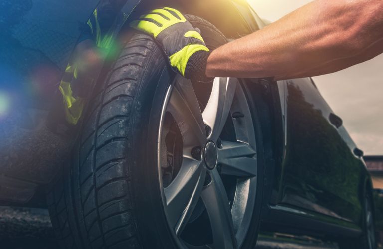 a technician's hand on a tire