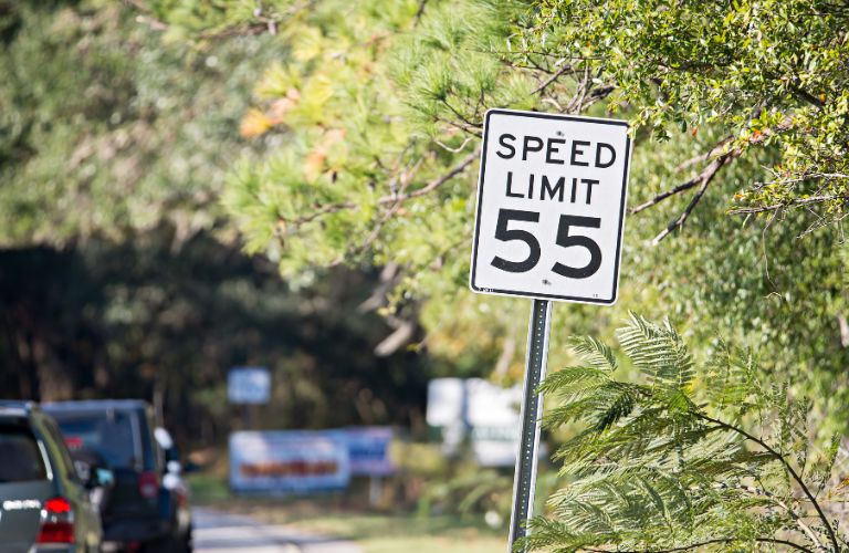 image of cars and a speed limit board