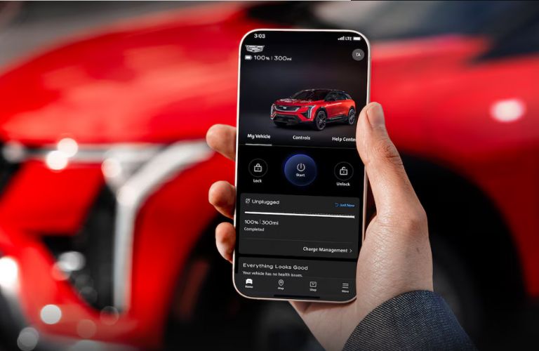 a hand checking the Cadillac EV charging status in phone