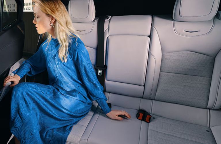 a woman sitting on the rear seat of the 2025 Cadillac XT4