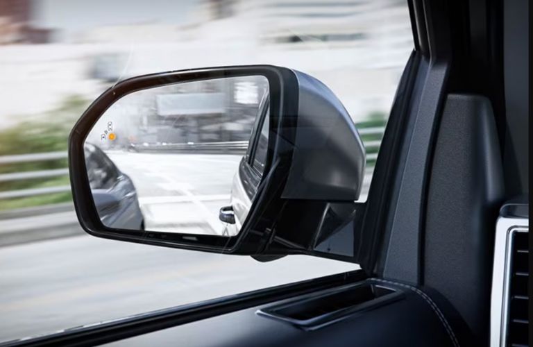 image of Blind Spot Assist in action in the side view mirror of a car