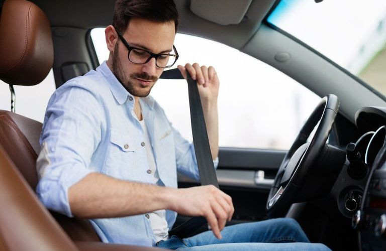 a man putting on a seatbelt